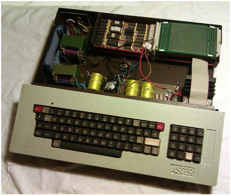 The integrated Aster computer with top cover removed, exposing the power supply (un-isolated) and double-sided card stack.